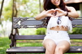Young woman putting hands together in heart shape (focus on her smile) - PhotoDune Item for Sale