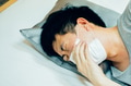 Young Asian man coughing and suffering in medical mask inside home bedroom - illness and fever - PhotoDune Item for Sale