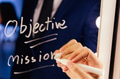 Smart business man writing the word Objective Mission on the mirror board - PhotoDune Item for Sale