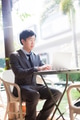 Young Asian businessman working with his laptop in outdoor scene against the light - PhotoDune Item for Sale