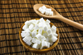 Sugar Cubes in Bowl and on Wooden Spoon over Wooden Background - PhotoDune Item for Sale