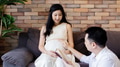 Asian husband reading a book for his wife - PhotoDune Item for Sale