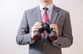 Businessman looking for something with binoculars - PhotoDune Item for Sale