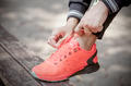 Young woman tying her shoes, prepared for jogging - PhotoDune Item for Sale