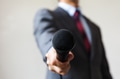 Man in business suit holding a microphone - PhotoDune Item for Sale
