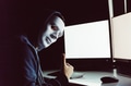 hacker giving thumbs up while using a computer with empty blank white screen in the dark room - PhotoDune Item for Sale