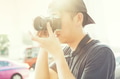 Portrait of young photographer shooting photo with camera in summer time - PhotoDune Item for Sale