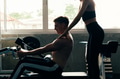 Young man at gym, training hard and pulling weights in seated cable row machine - PhotoDune Item for Sale