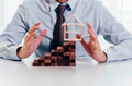 businessman using hand to protect residential house and real estate building - PhotoDune Item for Sale