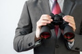 Businessman looking for something with binoculars - PhotoDune Item for Sale