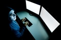 Top view of male hacker in mask under hood using computer to hack into system - PhotoDune Item for Sale
