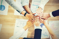 Multi-ethnic group of business people with hands together on desk - PhotoDune Item for Sale