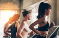 Young Caucasian sporty group of men and women running on treadmill in gym - PhotoDune Item for Sale