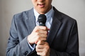 Man in business suit holding a microphone - PhotoDune Item for Sale