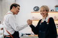 Hairdressers giving high-five in parlour - PhotoDune Item for Sale