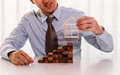 businessman putting on a house model on top of stack of blocks - PhotoDune Item for Sale