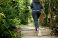 Young athletic woman running on forest trail - PhotoDune Item for Sale