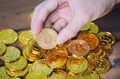 Close-up of businessman counting and holding bitcoin sign of coins - PhotoDune Item for Sale