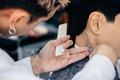 Happy young hairdresser trimming client hair - PhotoDune Item for Sale