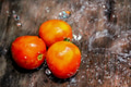 Red Tomato on wooden plate with water splash - PhotoDune Item for Sale