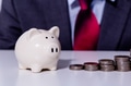 businessman and stack of coins implying growth in money investment - PhotoDune Item for Sale