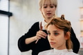 Young woman in parlour getting hairstyling - PhotoDune Item for Sale