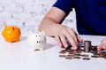 Young man collecting money coins and allocate coins into categories - PhotoDune Item for Sale