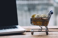 Shopping cart filled with piles of cryptocurrency bitcoin coins with computer laptop - PhotoDune Item for Sale