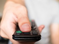 Close up of man pressing a button on remote control (shallow depth of field and focus on thumb) - PhotoDune Item for Sale