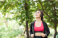 Asian woman jogger listening to music and running in the outdoor park. female fitness model - PhotoDune Item for Sale