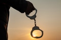 Business Man holding handcuffs after releasing over sunset background - PhotoDune Item for Sale