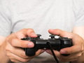 A young man holding game controller playing video games - PhotoDune Item for Sale