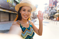 Young brunette woman using a mobile phone takes a self video selfie with attractive smile. - PhotoDune Item for Sale