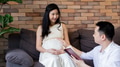 Asian husband reading a book for his wife - PhotoDune Item for Sale