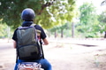 Back of Young happy and handsome male motorcyclist in helmet riding on motorbike on country road. - PhotoDune Item for Sale