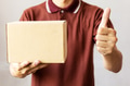 Delivery man carrying a cardboard box giving thumbs up - PhotoDune Item for Sale