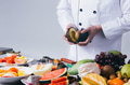 Chef preparing fruits for fruit salad over white background - PhotoDune Item for Sale