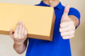 Delivery man carries a cardboard package - PhotoDune Item for Sale