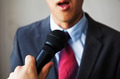 Man in business suit holding a microphone - PhotoDune Item for Sale