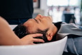Barber washing head client in barbershop - PhotoDune Item for Sale