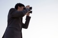 Businessman looking for something with binoculars - PhotoDune Item for Sale