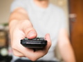 Close up of man pressing a button on remote control (shallow depth of field and focus on thumb) - PhotoDune Item for Sale