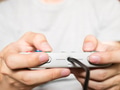 A young man holding game controller playing video games - PhotoDune Item for Sale