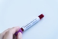 Hands holding blood Coronavirus (Covid 19) sample test for positive values - PhotoDune Item for Sale