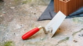 used trowel with a red grip outdoor renovation - PhotoDune Item for Sale