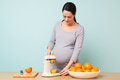 Pregnant woman making fresh orange juice. - PhotoDune Item for Sale