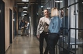 Two businesspeople talking together in an office hallway - PhotoDune Item for Sale