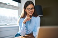 Positive self-employed woman working near window - PhotoDune Item for Sale