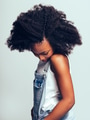 Shy young African girl standing sideways and looking down - PhotoDune Item for Sale