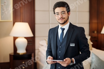 Young confident head manager of luxurious hotel looking at camera